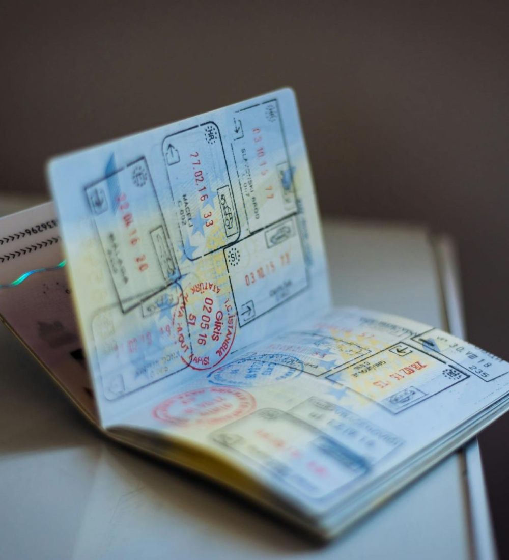 Open passport with entry and exit stamps from several countries