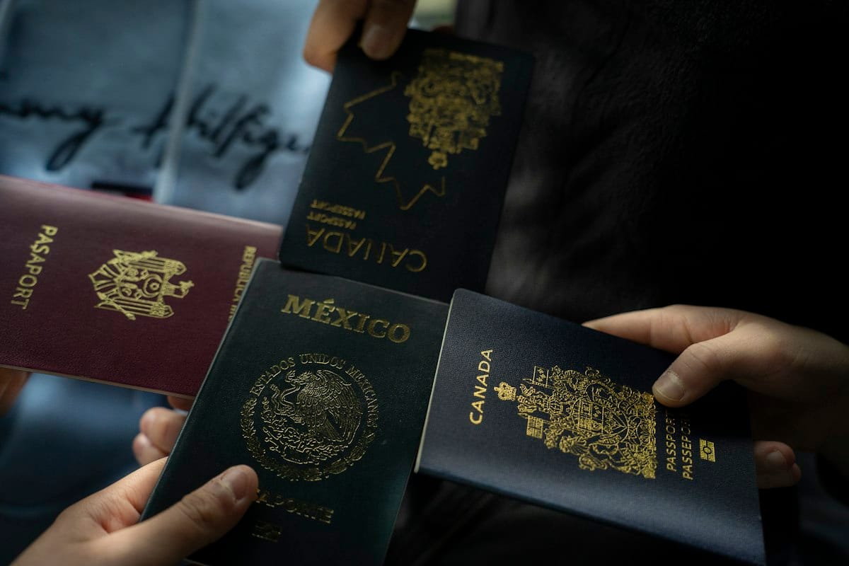 Hands holding passports from several countries