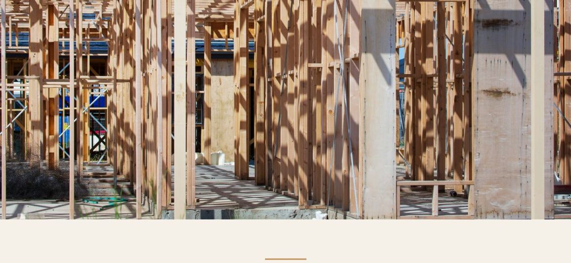 Timber house frame under construction, with the article title: New Domestic Building Contract Laws in Victoria